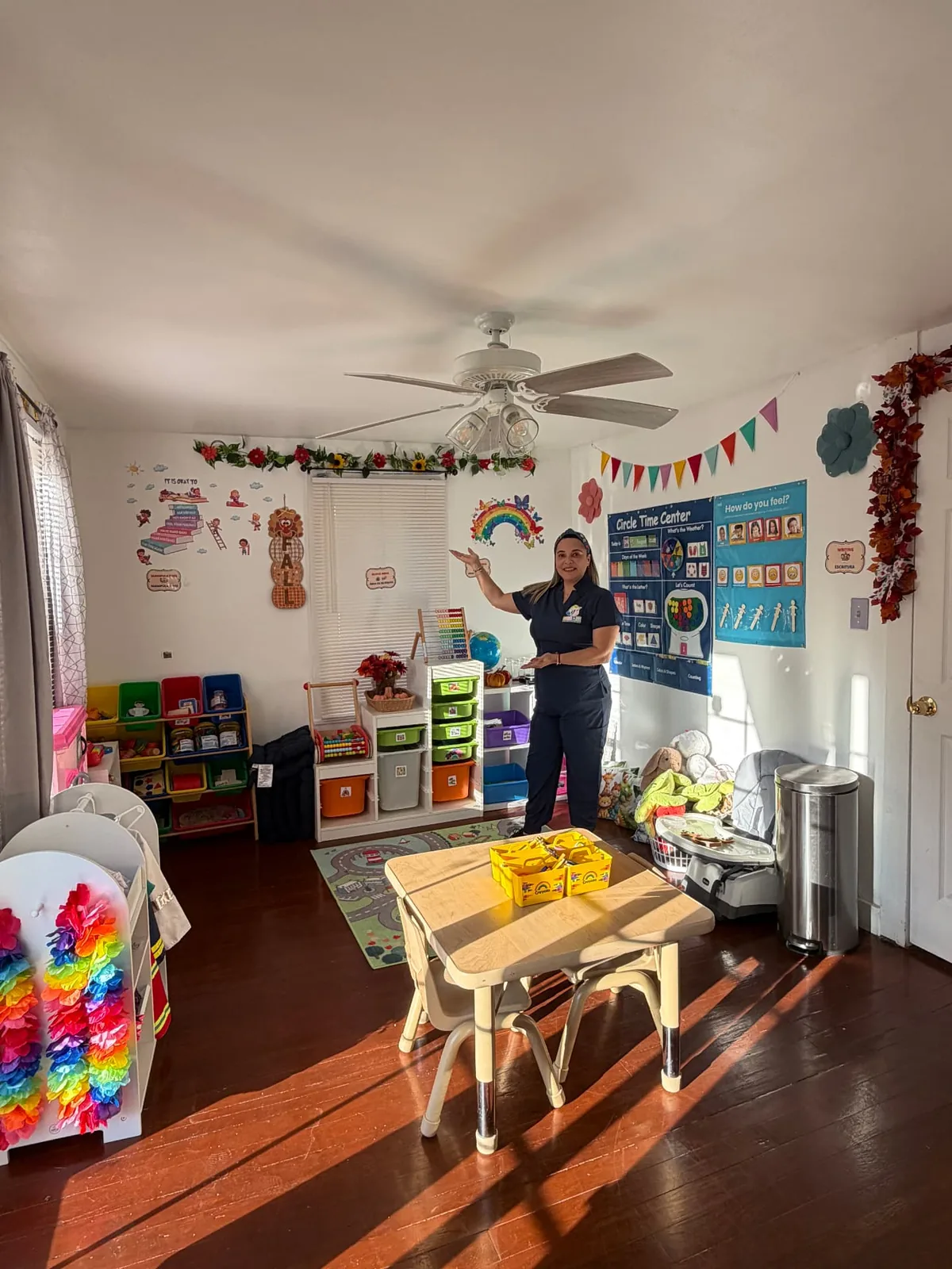 The daycare owner presenting a classroom with learning materials and child-sized furniture.