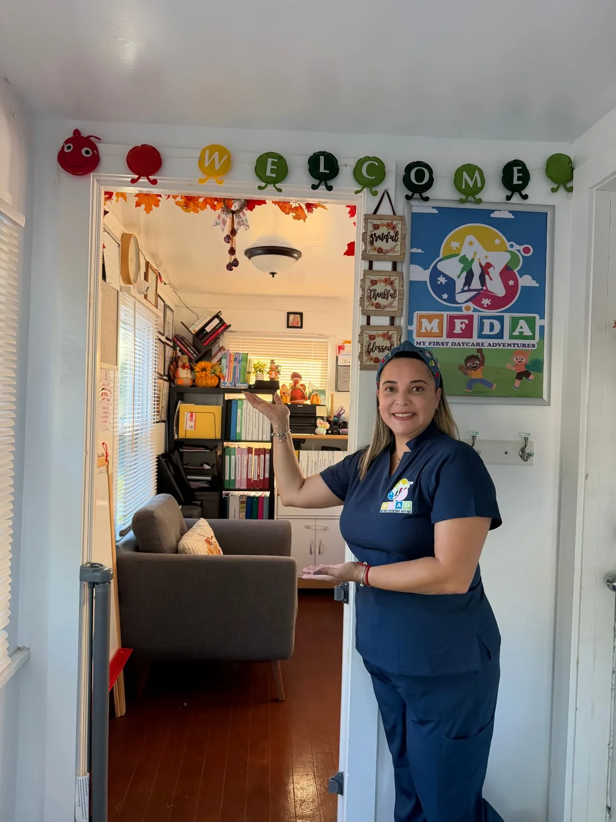 The daycare owner welcoming visitors at the entrance.